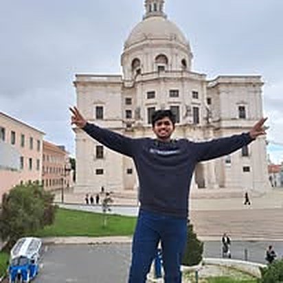 Saiful Islam in front of a historic domed building in Lisbon